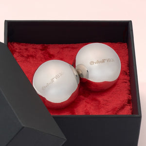 Close-up of two Viball VB36 36 mm medical Kegel balls made of anti-allergenic stainless steel for women and men in a black box on red velvet.