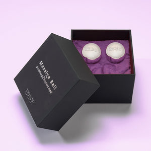 Theros® Massive Ball MB32-2 – A pair of 32 mm large solid balls made of anti-allergenic stainless steel for women and men for pelvic floor training in horizontal positions or for prostate stimulation in a black box on dark purple velvet.