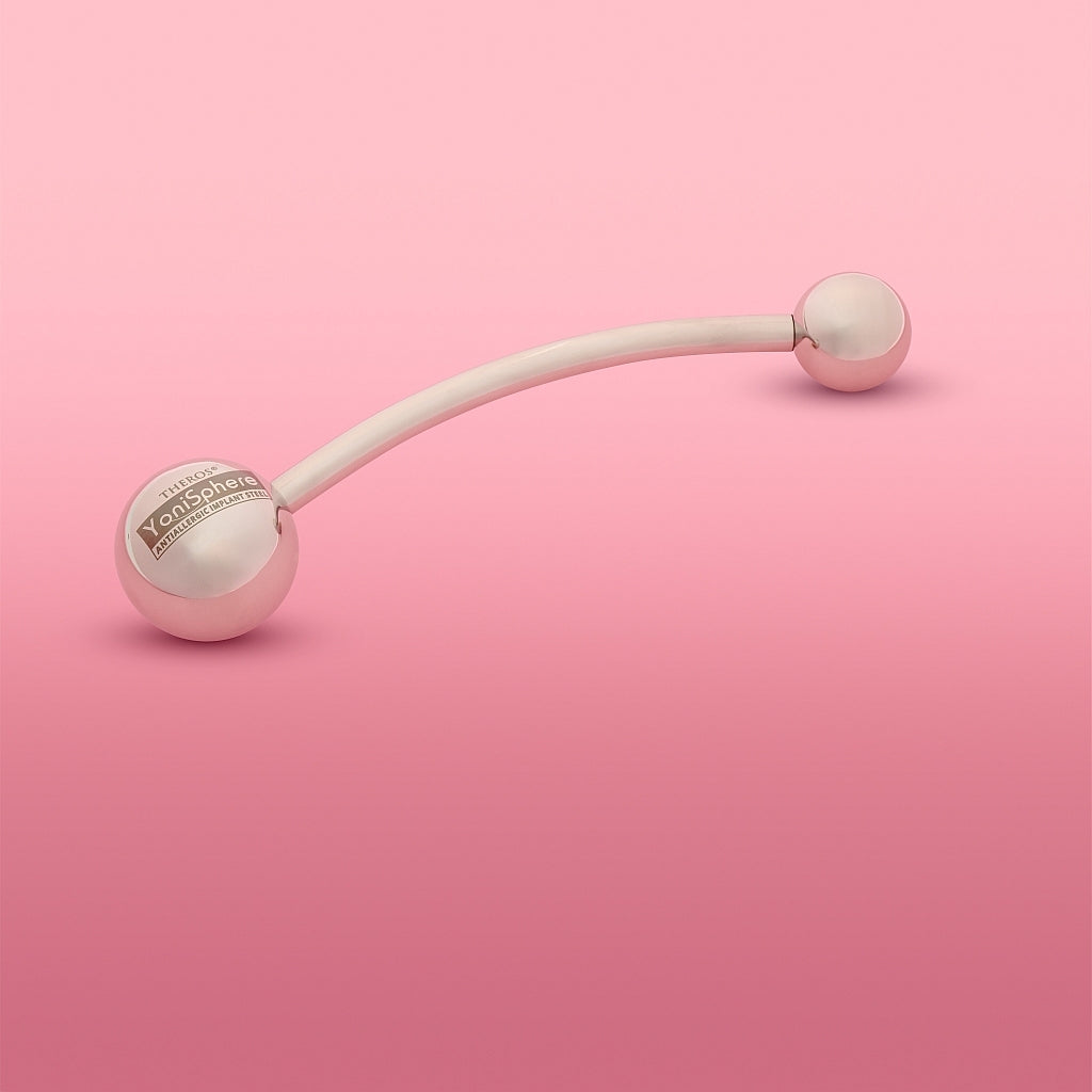 Theros® YoniSphere YS32: Ergonomic massage device for the pelvic floor and vagina for mental and physical relaxation, consisting of a slightly curved rod with a 45 mm ball as a handle with logo on one side and an interchangeable massage ball in size 32 mm on the other side. Left view.